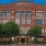 a large brick building with trees in front of it