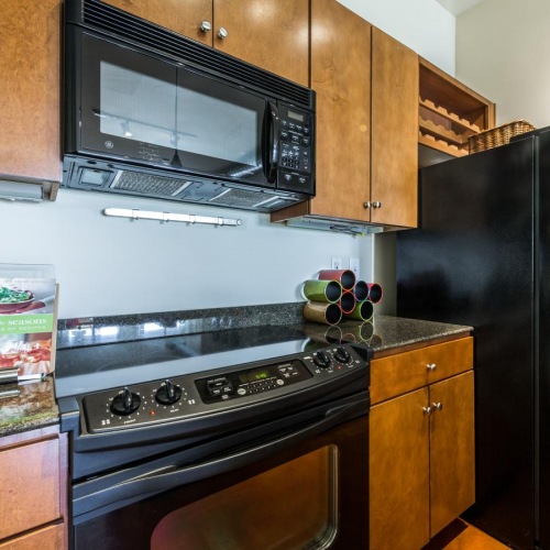 Spacious kitchens with thoughtful details a kitchen with a black refrigerator